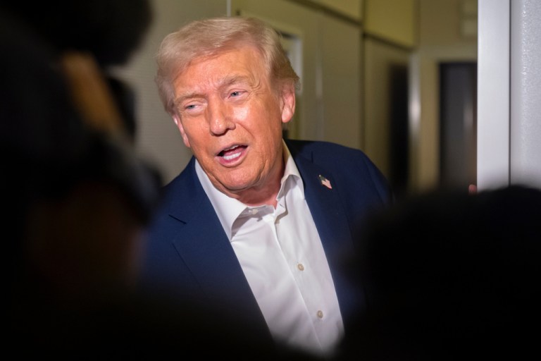 President Donald Trump speaks to reporters aboard Air Force One en route to Asia, Friday, Oct. 24, 2025. (AP Photo/Mark Schiefelbein)