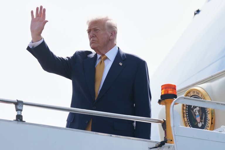 President Donald Trump waves outside of Air Force One.