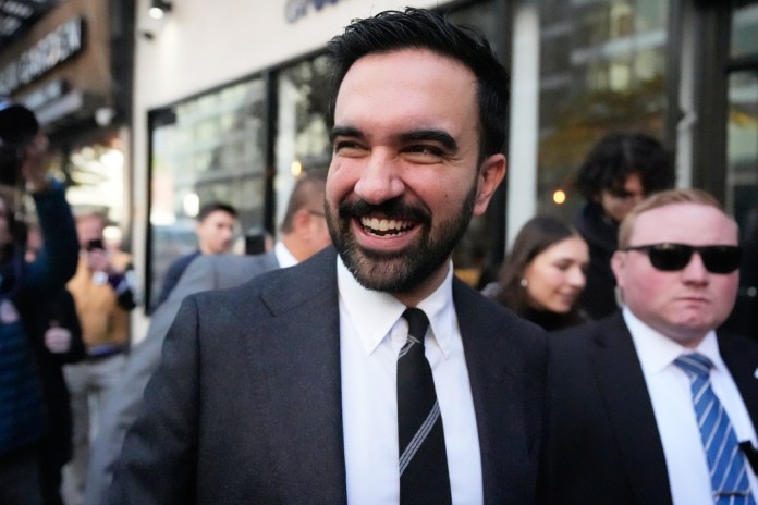 New York City mayoral candidate Zohran Mamdani tries to talk to pedestrians while surrounded by reporters in New York, Monday, Oct. 27, 2025.