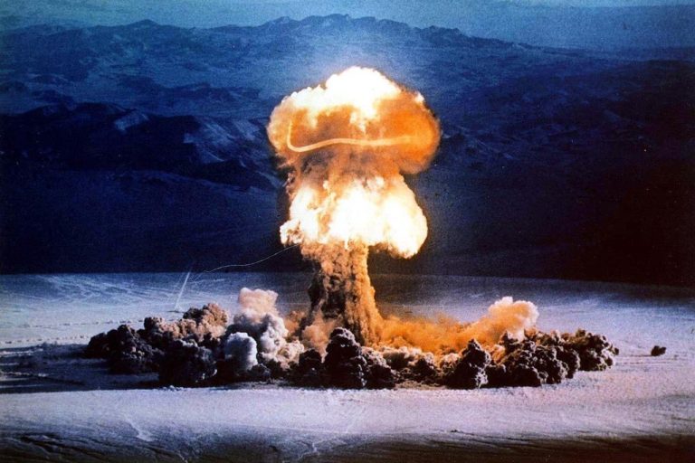 A mushroom cloud rises from a test blast.