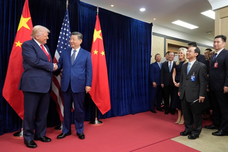 President Donald Trump shaking hands with Chinese President Xi Jinping.