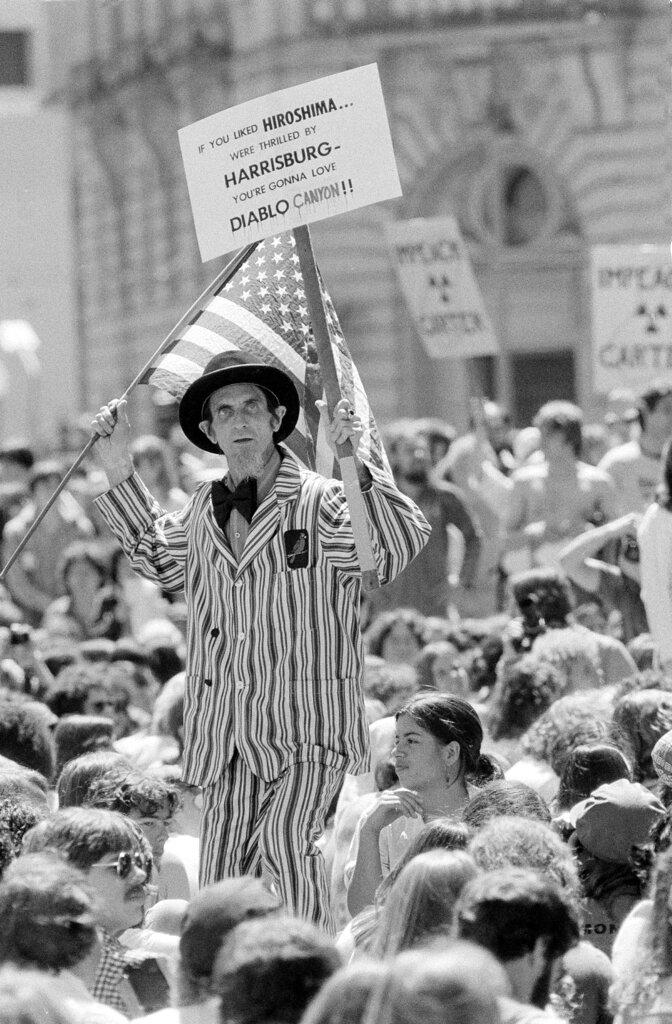 Franklin Burke from San Francisco wears an Uncle Sam costume and holds an American flag and an anti-nuclear sign during a large rally in front of San Francisco City Hall, April 7, 1979. 