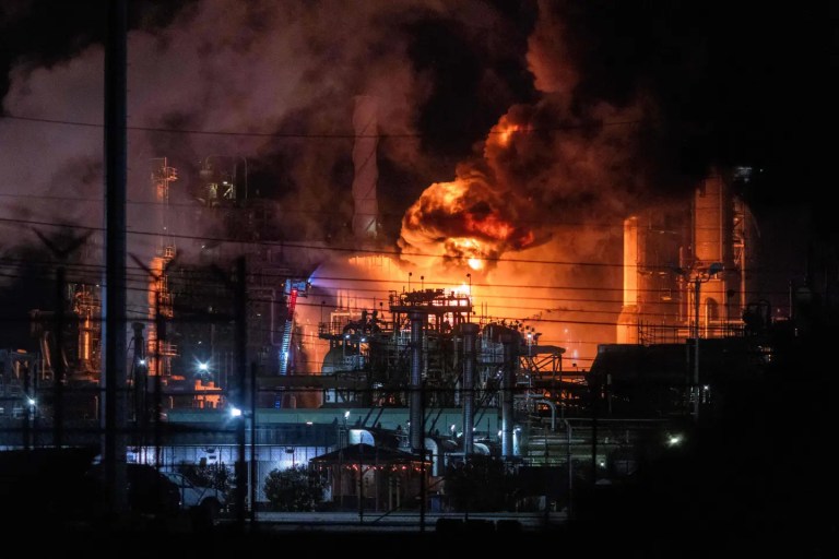 Flames rise from the Chevron refinery in El Segundo, California, Thursday, Oct. 2, 2025. (AP Photo/Ethan Swope)