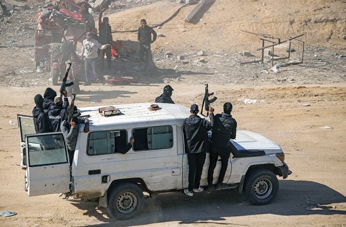 Hamas fighters secure aid trucks.