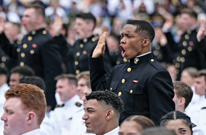 Marines stand and take their oath during the U.S. Naval Academy graduation in Annapolis, Maryland, May 23, 2025. (Brendan Smialowski/AFP/Getty)
