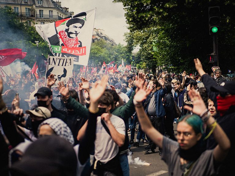 Crowds raise their hands during an anti fascist demonstration to mark the twelfth anniversary of the death of anti fascist activist Clement Meric in Paris France on June 8, 2025. (Photo by Bastien Ohier / Hans Lucas via AFP) (Photo by BASTIEN OHIER/Hans Lucas/AFP via Getty Images)