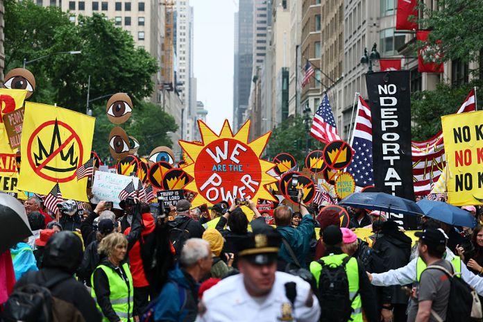 People march in the "No Kings" protest along Fifth Avenue on June 14, 2025 in New York, New York. Hundreds of marches and protests as part of a "national day of peaceful protest" against the Trump administration are happening across the United States today in opposition to his presidency and his policies. The national protest comes as President Donald Trump's military parade celebrating the 250th anniversary of the U.S. Army is taking place in Washington, DC. Today's parade coincides with President Trump's birthday. (Photo by Michael M. Santiago/Getty Images)