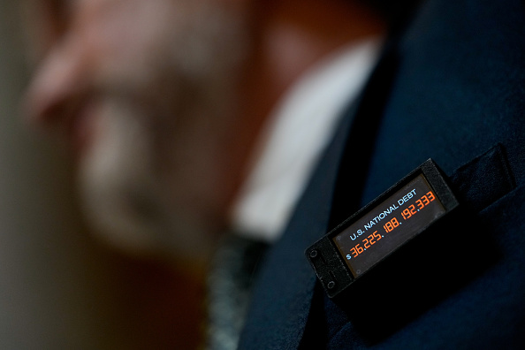 Representative Thomas Massie, a Republican from Kentucky, wears a digital pin with the US national debt.