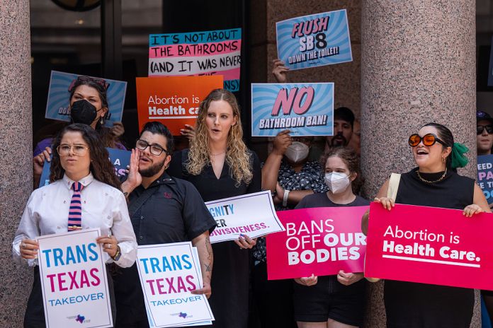 LGBTQ activists rally against the proposed bathroom bill and abortion pills bill in the outdoor rotunda at the Capitol in Austin, Friday, Aug. 22, 2025. (Mikala Compton/The Austin American-Statesman via Getty Images)