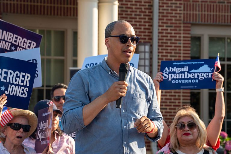 Jay Jones, Virginia's Democratic attorney general candidate, speaks to an audience holding signs for Democratic Virginia gubernatorial candidate Abigail Spanberger.