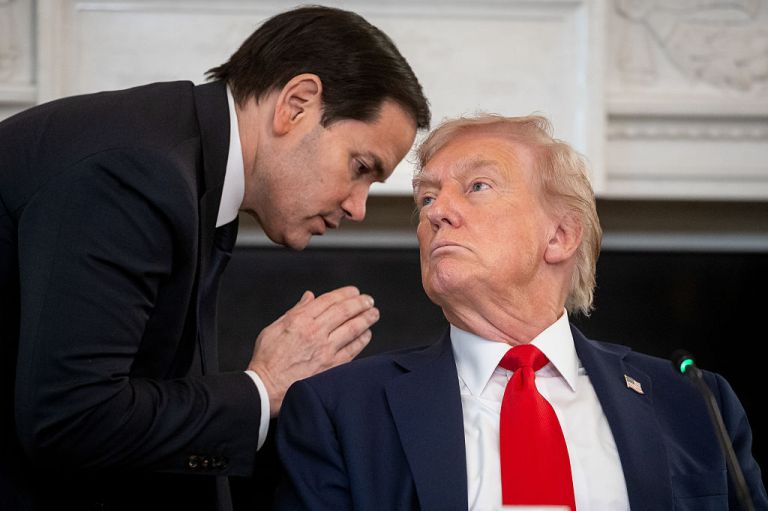 Marco Rubio, US secretary of state, left, and US President Donald Trump during a roundtable on Antifa in the State Dining Room of the White House in Washington, DC, US, on Wednesday, Oct. 8, 2025. Trump instructed members of his cabinet to move to declare Antifa a foreign terrorist organization at an event that highlighted his efforts to crack down on the loose collective of far left-wing groups. Photographer: Francis Chung/Politico/Bloomberg via Getty Images
