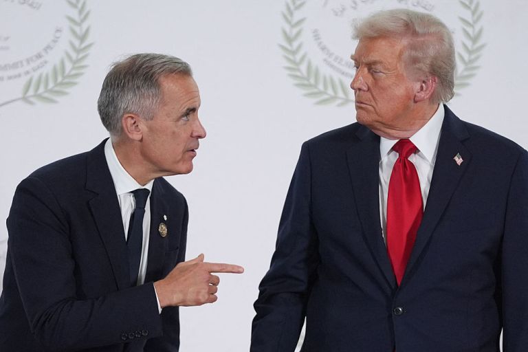 Canadian Prime Minister Mark Carney points at President Donald Trump as they speak.