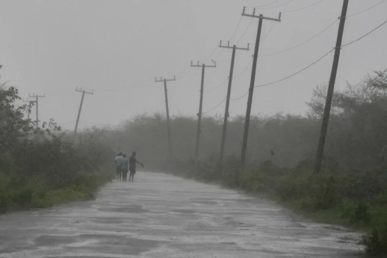 4 of 8 | People walk along a road during the passing of Hurricane Melissa in Rocky Point, Jamaica, Tuesday, Oct. 28, 2025. (AP Photo/Matias Delacroix)