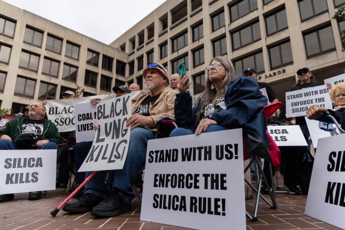 Coal miners, including some suffering from black lung disease, rally outside the Labor Department.