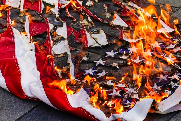 An American flag burns.
