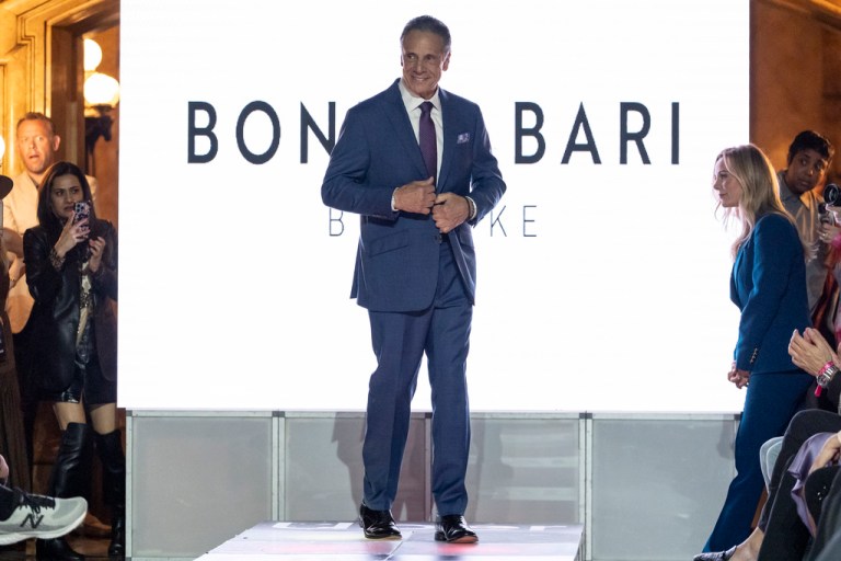 Andrew Cuomo walks on a runway.