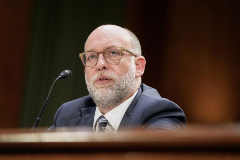 Russ Vought is seen testifying on Capitol Hill.