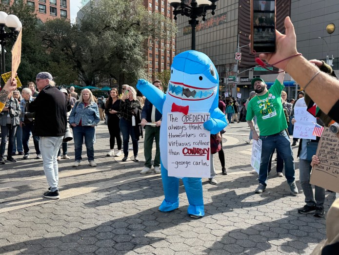Protester dressed in a costume at No Kings protest.