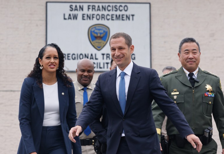 District Attorney Brooke Jenkins, front left to right, Mayor Daniel Lurie, Sheriff Paul Miyamoto and others walk to a news conference at the San Francisco Police Academy, Wednesday, Oct. 15, 2025, in San Francisco. (Lea Suzuki/San Francisco Chronicle via AP)