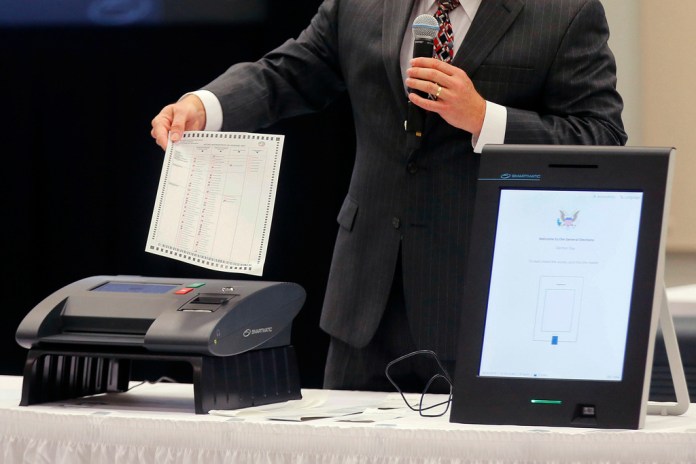 Smartmatic employee demonstrates a machine scanner