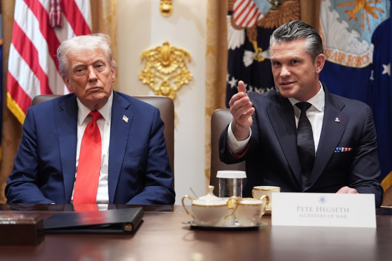 War Secretary Pete Hegseth speaks as President Donald Trump listens during a Cabinet meeting.
