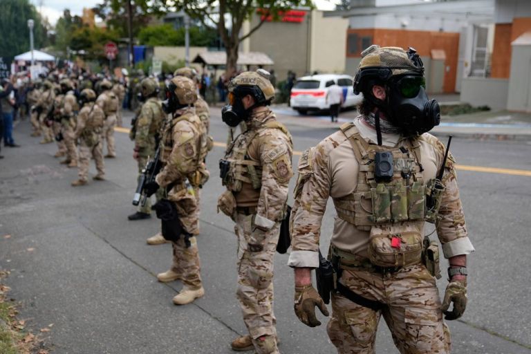 Federal officers are seen on the streets of Portland.