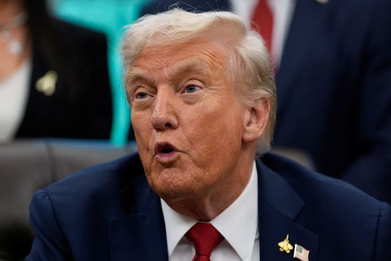 Trump speaks to the media in the Oval Office.