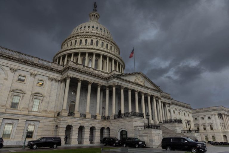 The U.S. Capitol with storm clouds overhead.