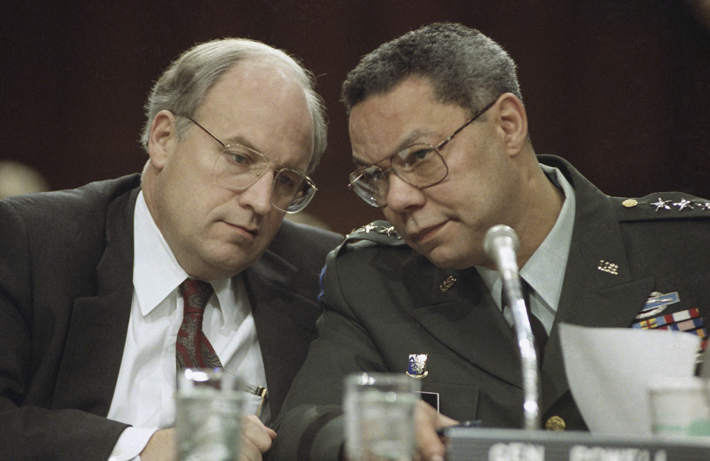 Dick Cheney, left, and Chairman of the Joint Chiefs, Gen. Colin Powell, huddle prior to testifying before the Senate Armed Services Committee in 1991