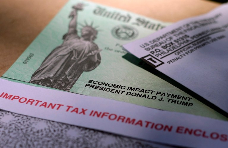FILE - President Donald J. Trump's name is printed on a stimulus check issued by the IRS to help combat the adverse economic effects of the COVID-19 outbreak in this April 23, 2020 photo taken in San Antonio.