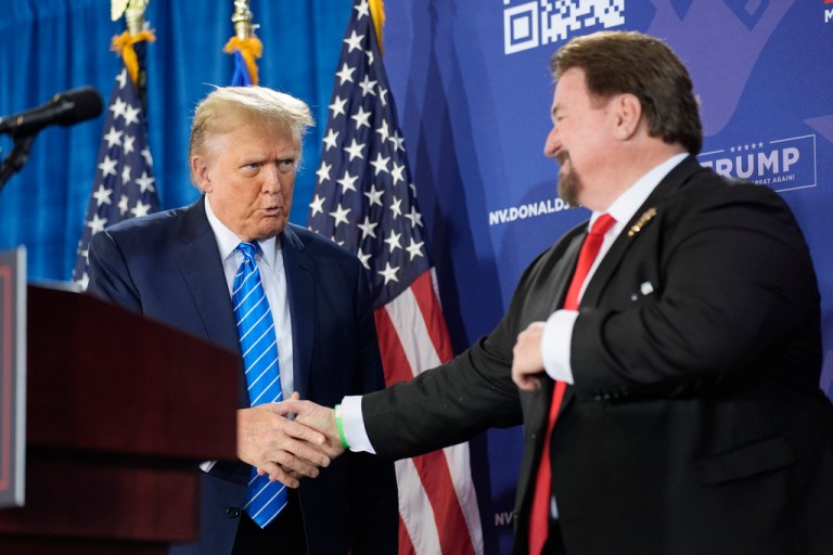 Nevada GOP chair Michael McDonald shakes hands with President Donald Trump.