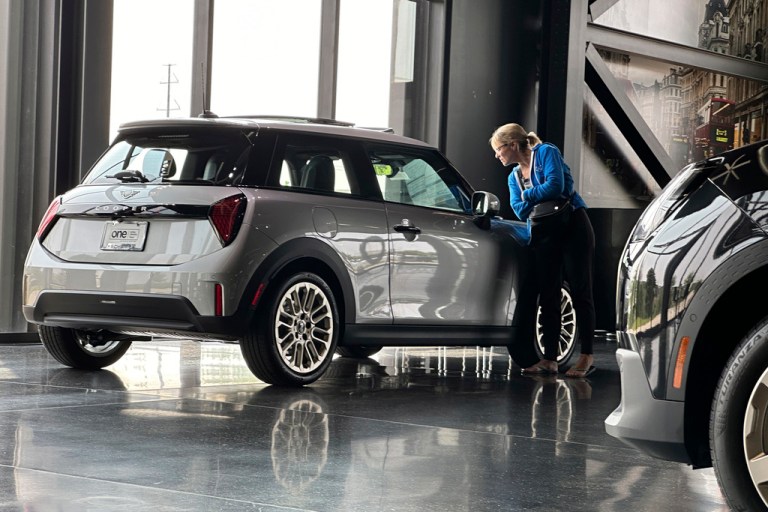 FILE - A prospective buyer looks over a 2025 Cooper S hardtop displayed at a Mini dealership on July 22, 2024, in Highlands Ranch, Colo.