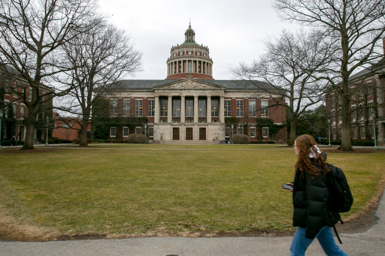 A student walks by the Rush Rhees Library at the University of Rochester.