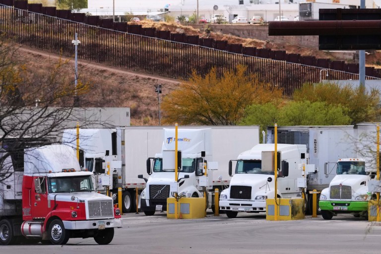 Shipping trucks drive through the commercial port of entry from the Mexico side of the US-Mexico border.