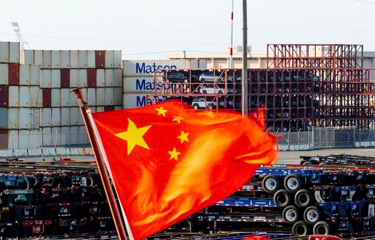 A Chinese flag flies from a ship at the Port of Oakland.