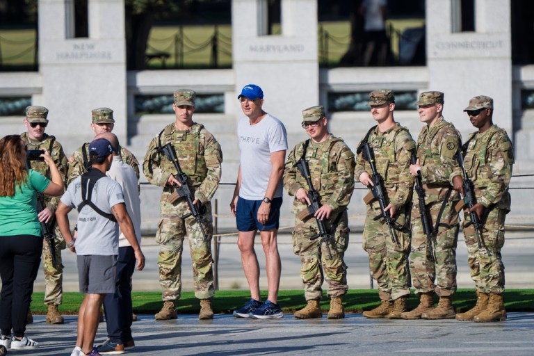 Doug Collins, center, poses for a photo with National Guard troops.
