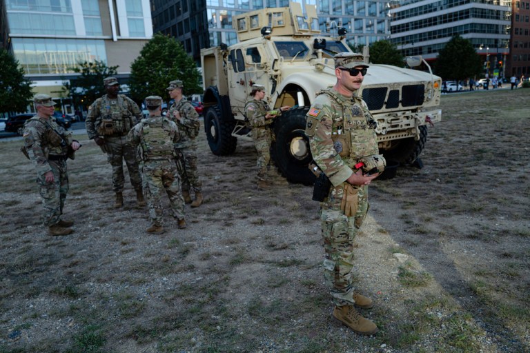 Members of the DC National Guard stand next to a Mine Resistant Ambush Protected (MRAP) near Nationals Park.