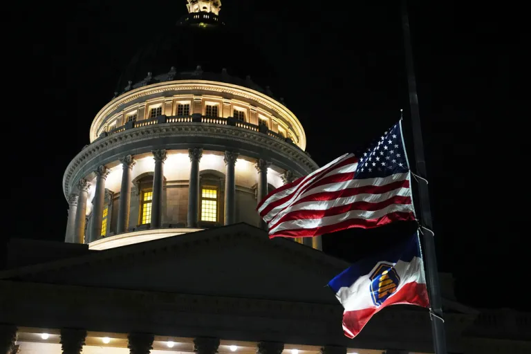 The American flag and the state flag of Utah fly at half-mast at the Utah state Capitol.