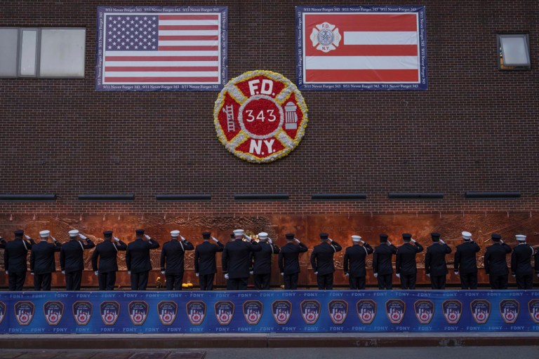 People take part in the annual Sunset Ceremony, to remember the 343 FDNY members who died during the 9/11 attacks, Thursday, Sept. 11, 2025 in New York. (AP Photo/Adam Gray)