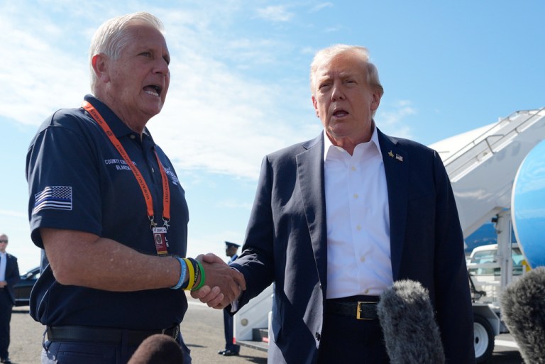 President Donald Trump, right, shakes the hand of Nassau County Executive Bruce Blakeman while speaking with reporters as Trump arrives on Air Force One at Republic Airport, Friday, Sept. 26, 2025, in Farmingdale, N.Y. (AP Photo/Alex Brandon)