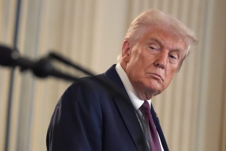 President Donald Trump listens during a news conference.