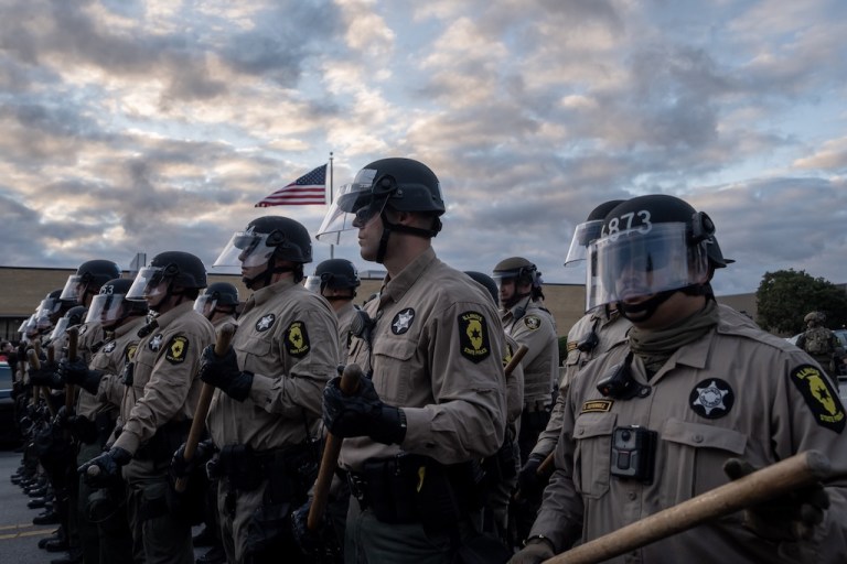 Illinois State Police move protesters back after declaring an unlawful assembly outside the U.S. Immigration and Customs Enforcement facility in Broadview, Ill., Saturday, Oct. 11, 2025. (AP Photo/Adam Gray)