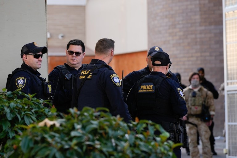 Law enforcement officers are seen outside a United States Immigration and Customs Enforcement (ICE) facility in Portland, Ore., Monday, Oct. 20, 2025. (AP Photo/Jenny Kane)