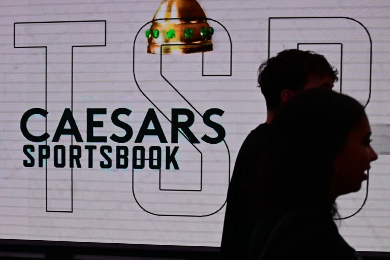 Fans walk past a sports gambling advertisement before an NBA basketball game between the Milwaukee Bucks and the Cleveland Cavaliers, Sunday, Oct. 26, 2025, in Cleveland.