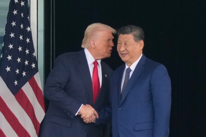 President Donald Trump and Chinese President Xi Jinping shake hands.