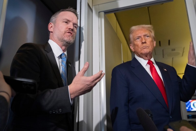U.S. Trade Representative Jamieson Greer, left, speaks with reporters aboard Air Force One as President Donald Trump listens, shortly after taking off from Busan, South Korea, en route to Joint Base Andrews, Md., Thursday, Oct. 30, 2025.