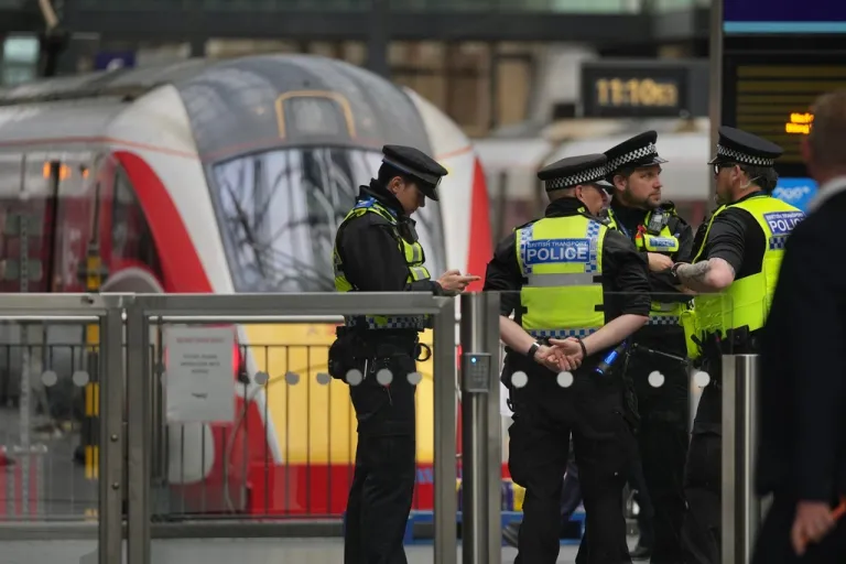 Police officers patrol King's Cross train station.