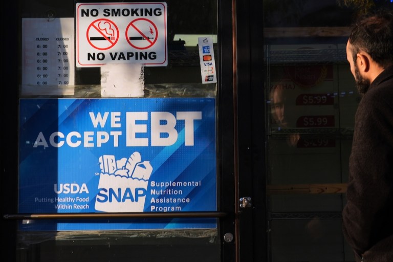 A customer walks into a bakery with a SNAP EBT information sign displayed on the front door in Chicago, Sunday, Nov. 2, 2025. (AP Photo/Nam Y. Huh)