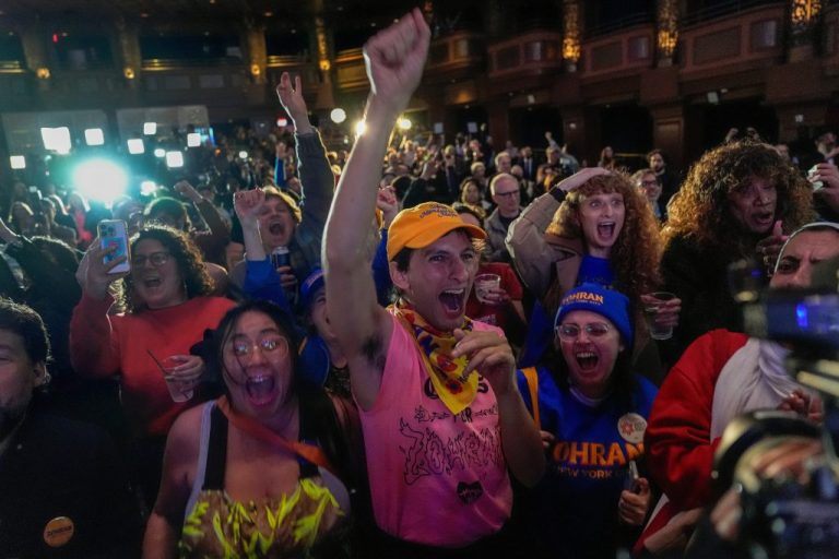 Supporters of Democratic mayoral nominee Zohran Mamdani cheer.