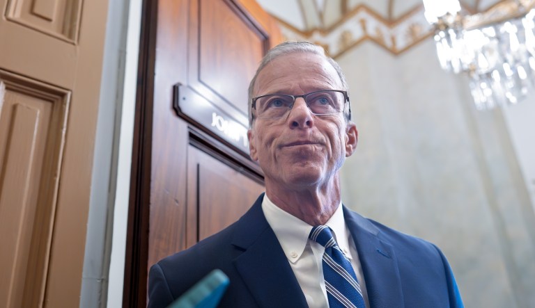 Senate Majority Leader John Thune, R-S.D., stands in the door of his office as he responds to reporters looking for updates on a plan to end the 38 day government shutdown, at the Capitol in Washington, Friday, Nov. 7, 2025. (AP Photo/J. Scott Applewhite)